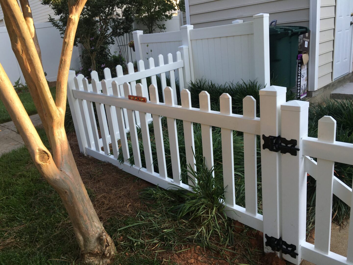 A white picket fence in front of a house.