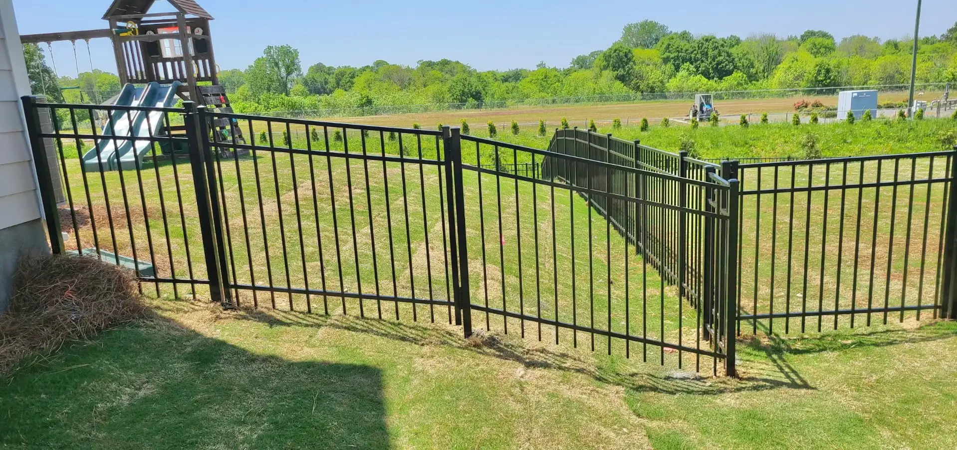 A fence that is made of metal and has a gate.